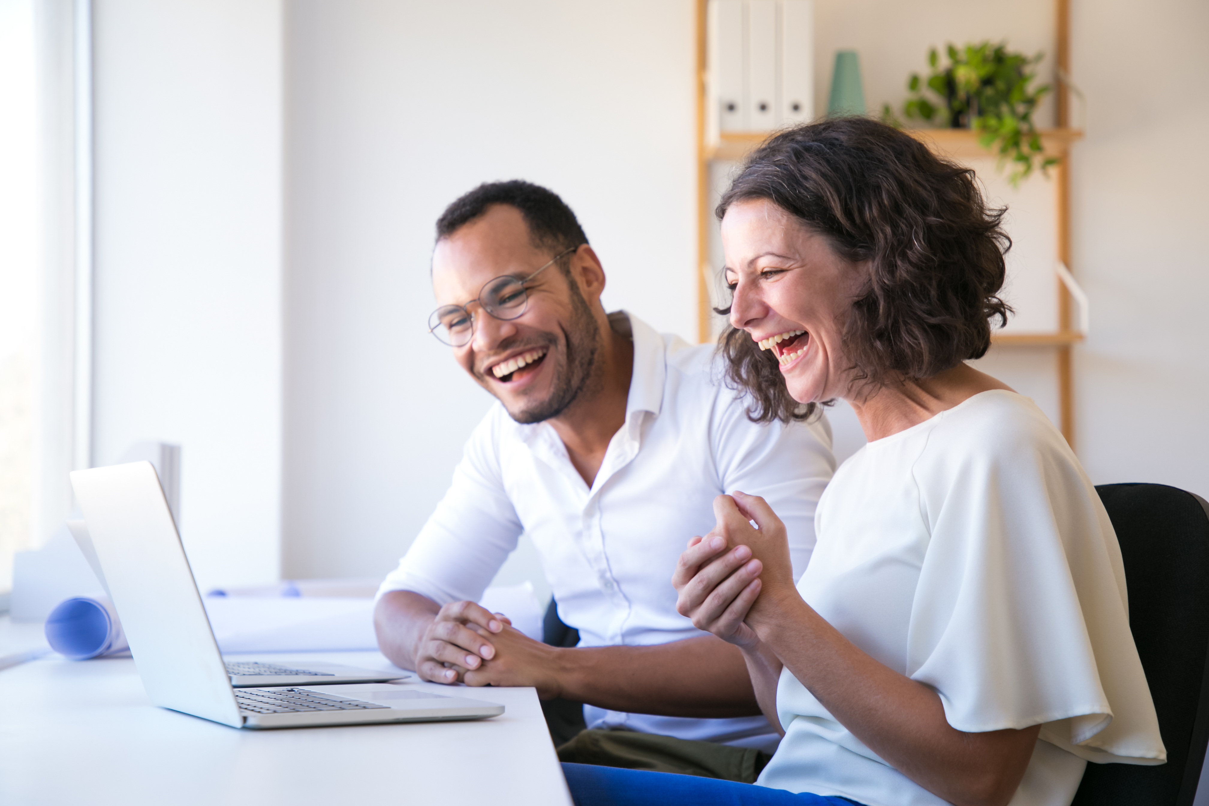 https://2688240.fs1.hubspotusercontent-na1.net/hubfs/2688240/cheerful-employees-looking-laptop-laughing.jpg